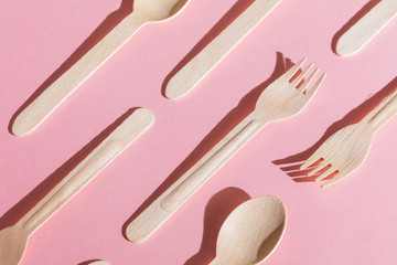 set of different spoons and forks on the table, game for counting, logic isolated pink background