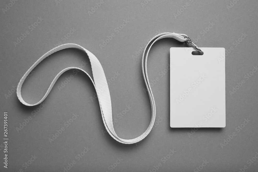 Poster empty layout layout on grey background. common blank label name tag hanging on neck with thread.