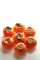 Ripe persimmon on white background 