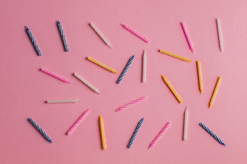 seamless pattern of many candles isolated on the blue background. messy party table