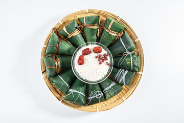 Freshly wrapped hazelnuts and white glutinous rice with red dates on a white background