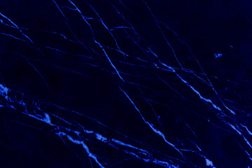 Black marble natural pattern for background, abstract neon blue light, copy space.