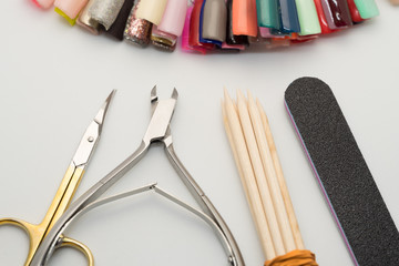 Fototapeta na wymiar Manicure tools on a white background. Scissors, nail file, sticks, etc.
