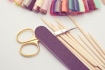 Manicure tools on a white background. Scissors, nail file, sticks, etc.