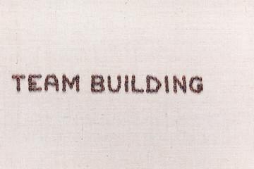 The words Team Building written with coffee beans, aligned to the left.