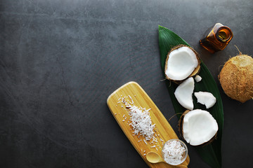 Coconut on a dark stone table. Coconut oil.