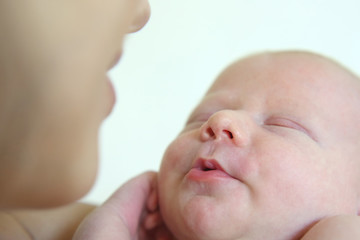 Portrait of a sleeping newborn baby with a mother close-up