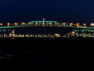 Fototapeta na wymiar Aukland Harbour Bridge at night, from the Birkenhead Whard, Waitemata Harbour, Auckland, New Zealand