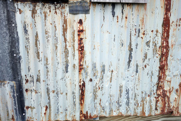 weathed and rusty white painted corrugated steel      