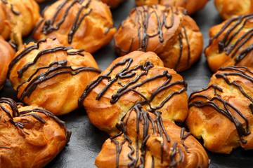 Delicious cakes eclairs on the table