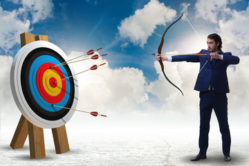 Businessman aiming arrow with bow