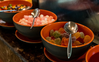 Set with different colorful candies,marmalades,marshmellow topping ion display