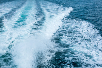 Water splash behind the ship or wake of speed boat in the ocean