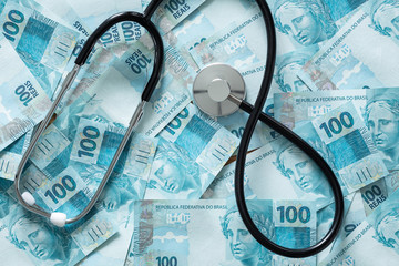 Brazilian money with a medical stethoscope as a concept of economy and currency strength