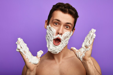 awesome crazy screaming shirtless man with open mouth and white face and hands posing to the...