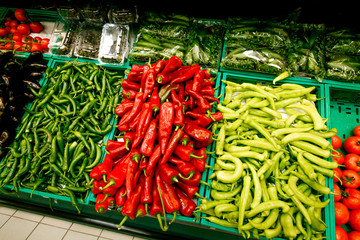 showcase in the supermarket with red yellow green pepper in the boxes