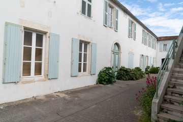 Fototapeta na wymiar Saint Martin de Re France picturesque village center white house and green shutter