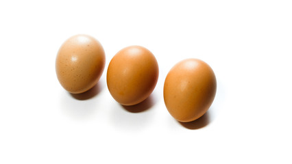three brown eggs isolated on white background