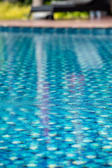 Fototapeta na wymiar Swimming pool in a hotel With clear and clean blue good looking and reflecting water in the morning.