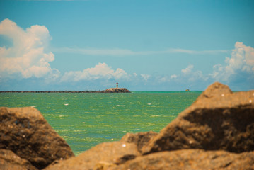 RECIFE, PERNAMBUCO, BRAZIL: Lighthouse on the horizon. Beautiful landscape with views of the rocks...
