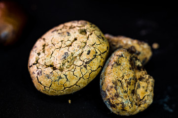Untreated cocoa beans on black background, close up, macro