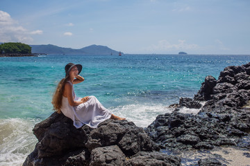 Happy  woman in white dress on tropical beach vacation