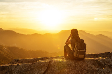 Hiker meets the sunset on the Moro rock in Sequoia national park, California, USA.