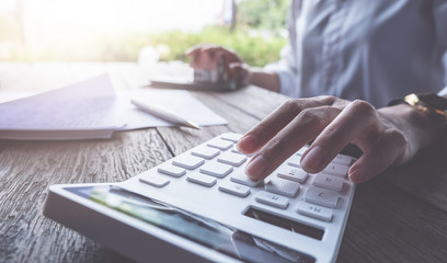 Business concept, Businessman using calculator to calculate loan plan