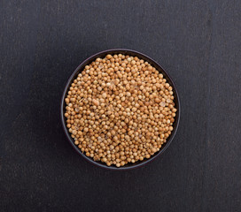 Coriander seeds  on black background