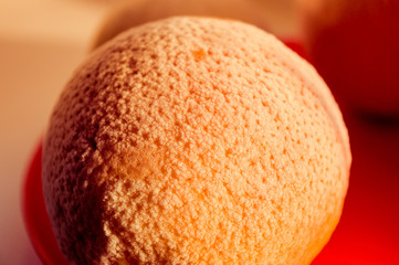 Frozen oranges and lemons on a red plate, covered in frost