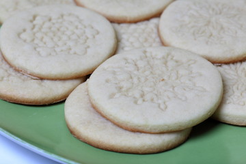Baked round blanks from rolled dough with an ornament. For making marshmallow sandwiches. Lie on a plate.