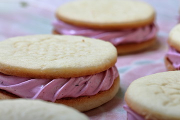 Cooked marshmallow sandwiches. They lie on food paper.