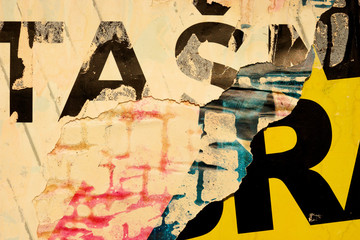 Fototapeta premium Old grunge ripped torn vintage collage colorful street posters creased crumpled paper surface backdrop