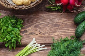 Frame on wooden background from fresh organic vegetables. A set of different vegetables.