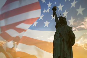 Double exposure with statue of liberty and American flag. © StockGood