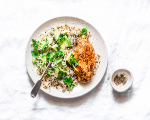 Quinoa, baked chicken breast, avocado, cheese, cilantro bowl on light background, top view. Healthy eating concept
