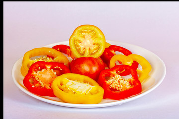 Sliced bell pepper red and yellow lies on the plate.