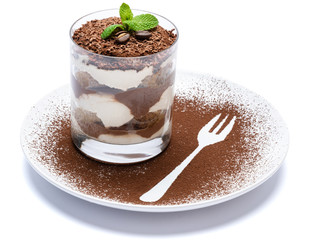 Classic tiramisu dessert in a glass on plate with fork silhouette isolated on a white with clipping path