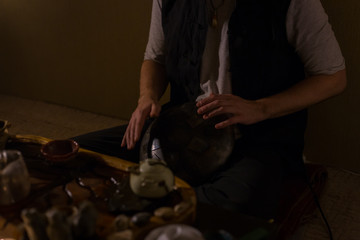 Man playing hang drum