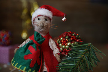 Closeup Santa Claus rat with a bag of gifts and Christmas tree. Chinese calendar symbol