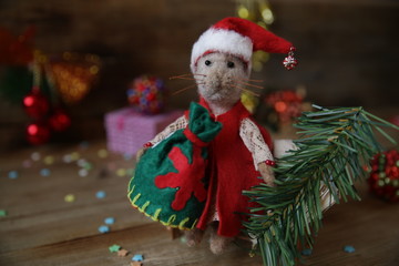 Christmas card with cute santa claus rat. Ornaments symbol of the year on the Chinese calendar. background of christmas toys and wood. Holidays, winter and holiday concept