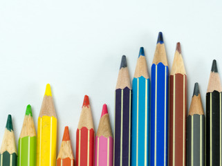 Fototapeta premium waves of colored pencils on a white background