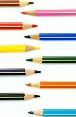 colored pencils facing each other on a white background