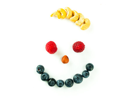 smiley face with berries and nuts and wild hair on a white background