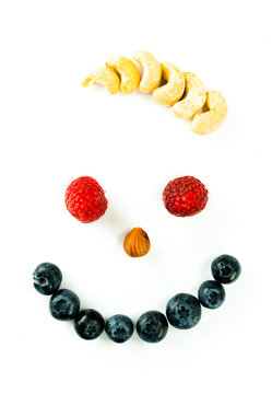 smiley face with berries and nuts and wild hair on a white background