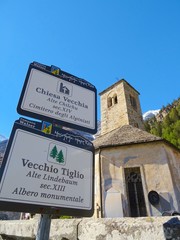 View of a church in the Italian Alps on a sunny day in the village of Macugnaga, Italy - April 2019