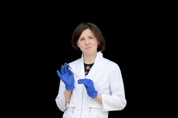 portrait of attractive woman doctor in white medical robe holding thermometer isolated on black background