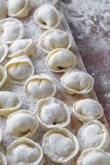 Traditional russian food. Homemade pelmens dumping with meat. Food background. 