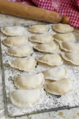 Fototapeta na wymiar Process of cooking homemade vareniki, Raw dumplings with cottage cheese. Top view.