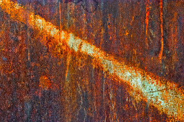Rusty iron sheet with line of light peeling paint in the diagonal section
